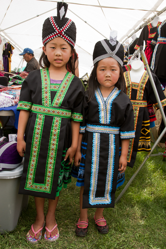 Rose Vang, 8, and her younger sister Cherry Vang, 5, pose in traditional Hmong clothing.