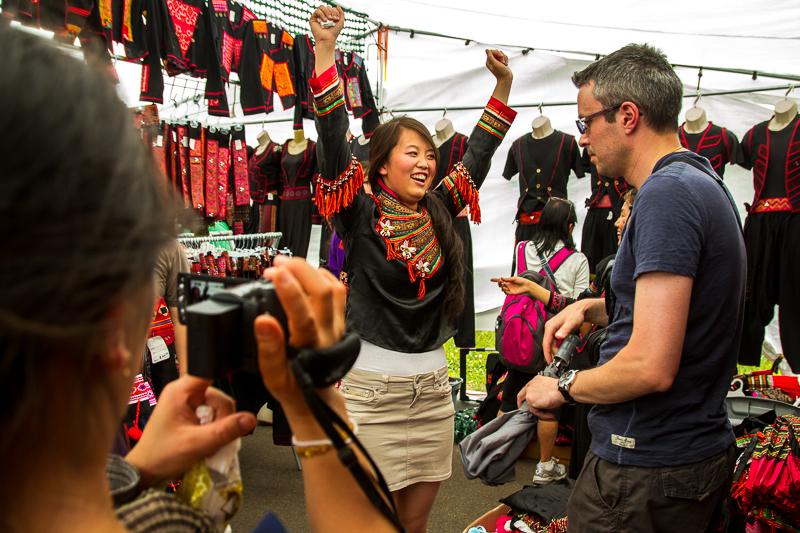 Melodie Vang, 24, tries traditional Hmong clothing on and asks her fiance Nicolas Raho, 34, to help her with taking the clothes off while her mother Vaj Kub, 47, videotaping the experience. Vang and her family are visiting from France.